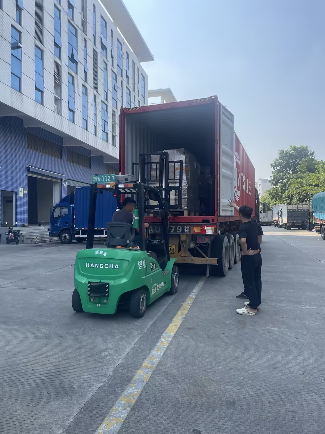 Forklift loading crated cargo into a shipping container in China
